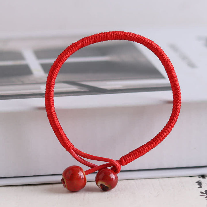 Braccialetto in ceramica con corda rossa portafortuna FengShui Buddha Stones