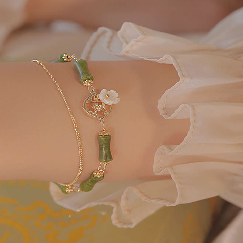 Bracciale Buddha Stones in rame placcato oro 14k con fiore di bambù, peridoto e doppio strato di ricchezza