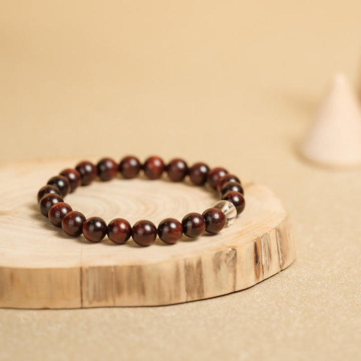 Braccialetto di protezione con piccole foglie di sandalo rosso e cristallo bianco Buddha Stones