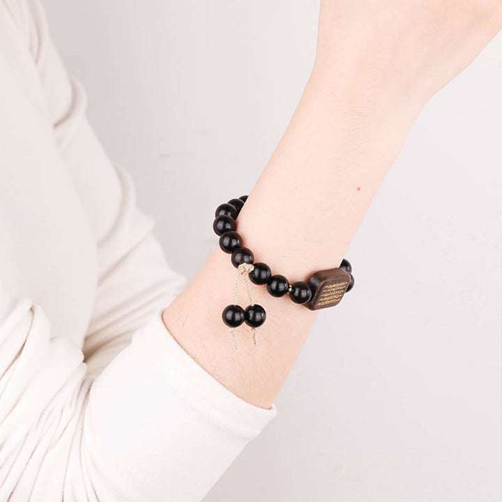 Braccialetto della pace con incisione della scrittura in legno di ebano Buddha Stones