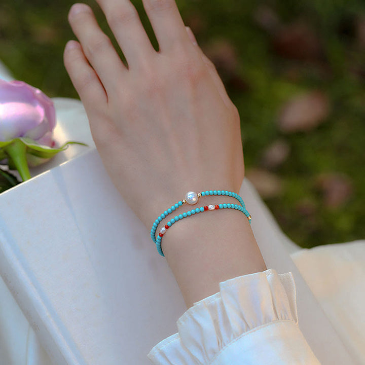 Braccialetto di protezione con piccole perle di agata rossa e turchese Buddha Stones