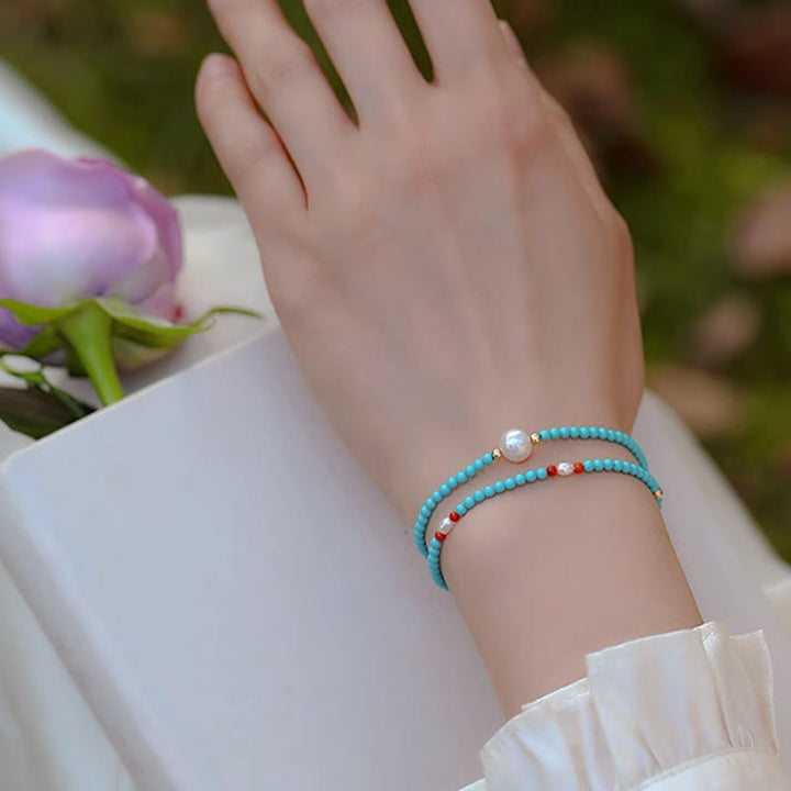 Braccialetto di protezione con piccole perle di agata rossa e turchese Buddha Stones