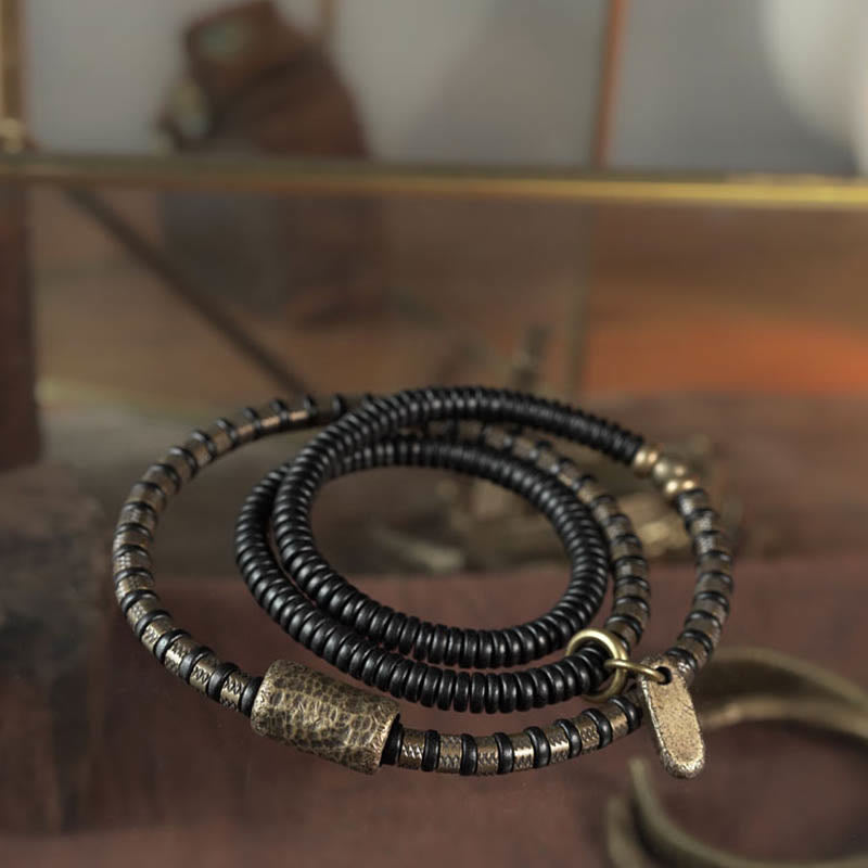 Braccialetto multistrato in rame con perline di legno di ebano tibetano e Buddha Stones