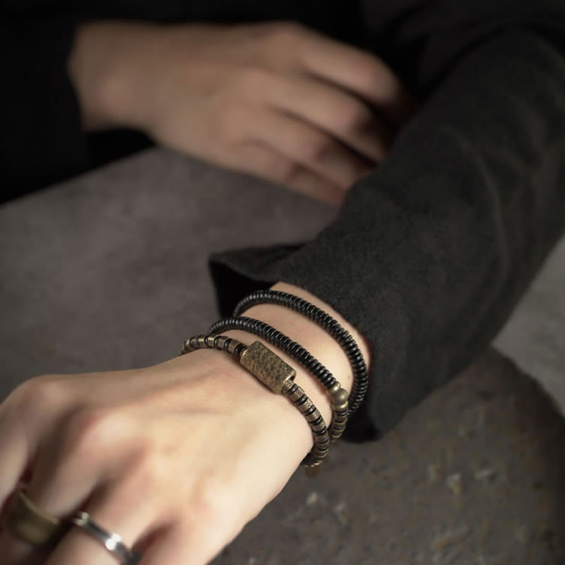 Braccialetto multistrato in rame con perline di legno di ebano tibetano e Buddha Stones