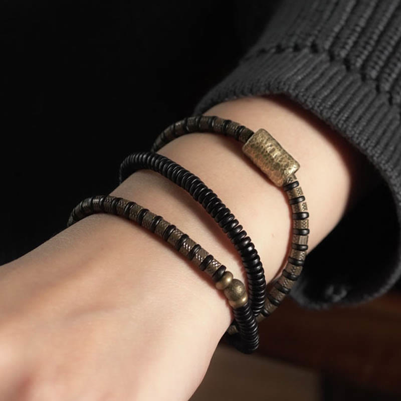 Braccialetto multistrato in rame con perline di legno di ebano tibetano e Buddha Stones