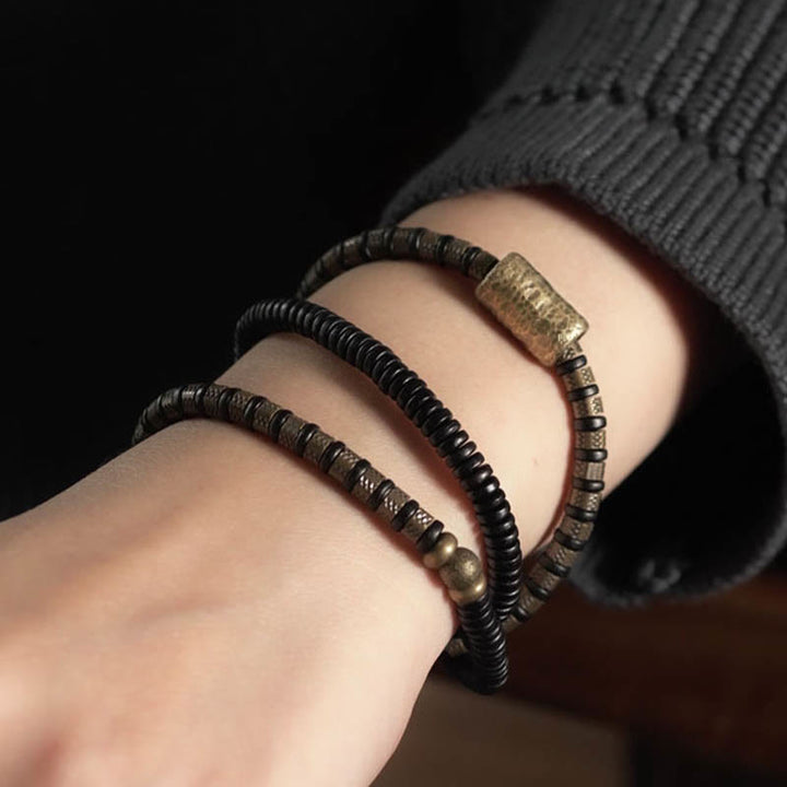 Braccialetto multistrato in rame con perline di legno di ebano tibetano e Buddha Stones