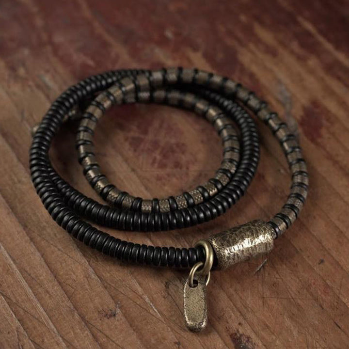 Braccialetto multistrato in rame con perline di legno di ebano tibetano e Buddha Stones