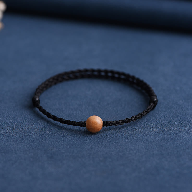 Bracciale intrecciato con perline di legno di pesca naturale Buddha Stones che allontanano gli spiriti maligni