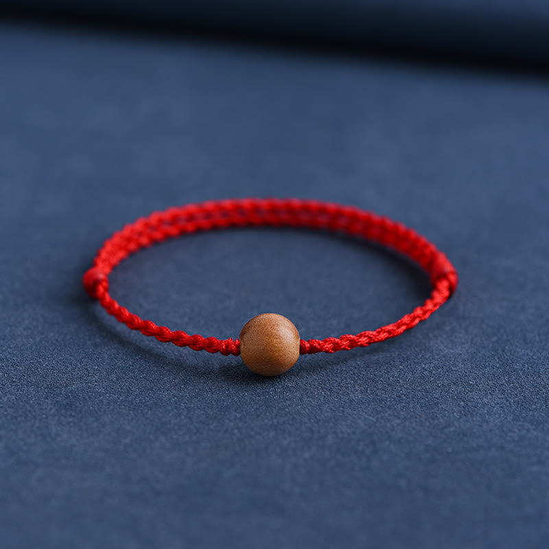Bracciale intrecciato con perline di legno di pesca naturale Buddha Stones che allontanano gli spiriti maligni