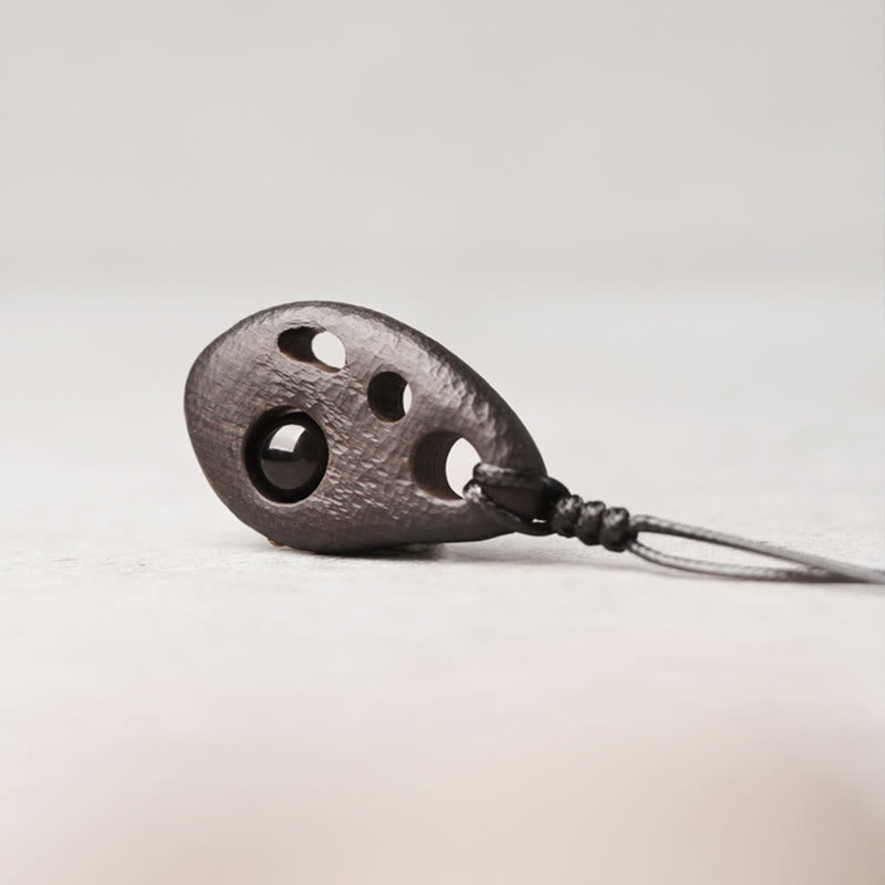 Collana con ciondolo in ossidiana intarsiata cava in legno di ebano Buddha Stones, pace e calma