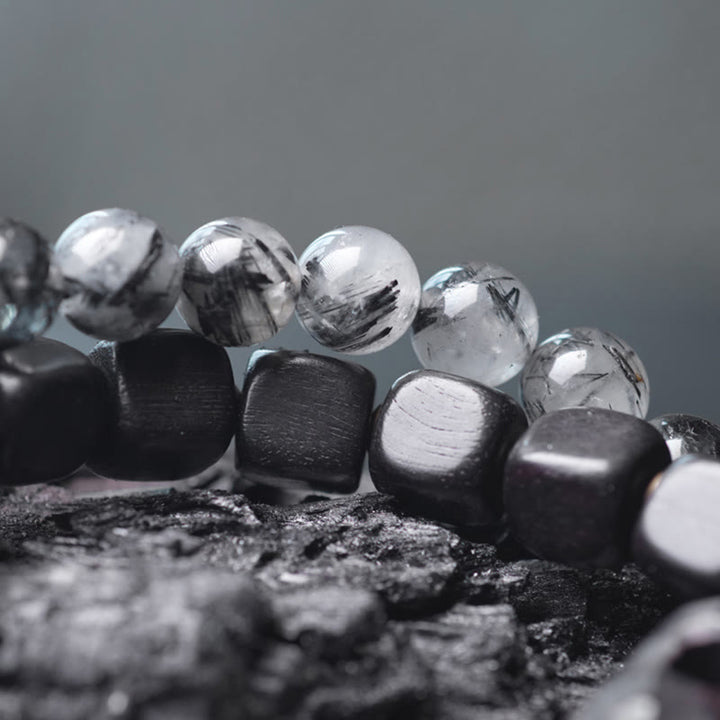 Braccialetto con bilanciere a doppio giro in ottone e rame, in legno di ebano e quarzo rutilato nero Buddha Stones