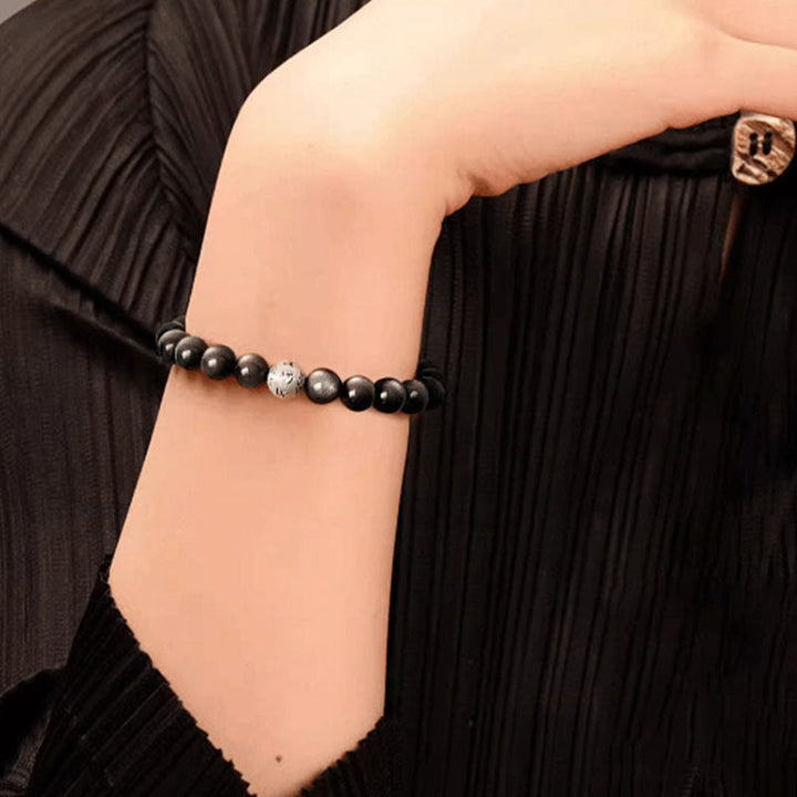 Bracciale di protezione Om Mani Padme Hum in ossidiana naturale lucida e argento Buddha Stones