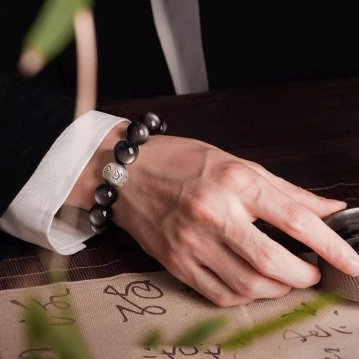Bracciale di protezione Om Mani Padme Hum in ossidiana naturale lucida e argento Buddha Stones