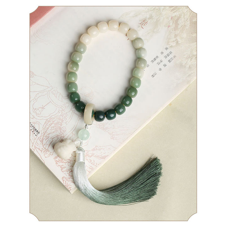 Buddha Stones Naturale Gradiente Bodhi Seed Fortuna Sacchetto di Denaro Loto Saggezza Nappa Polso Mala