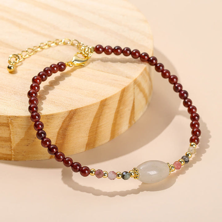 Bracciale Buddha Stones con perline di giada, tormalina e granato