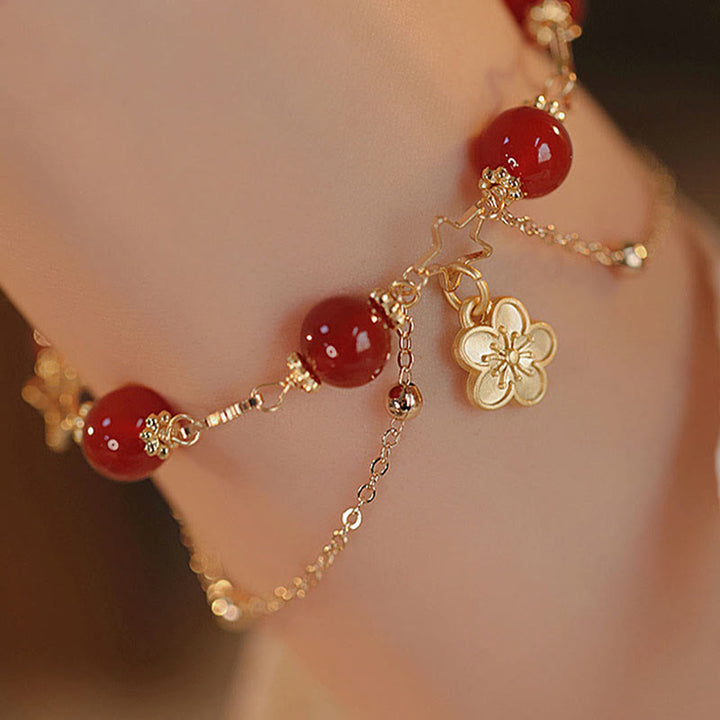 Bracciale Buddha Stones placcato oro 14k con ciondolo a forma di fiore di agata rossa e stella