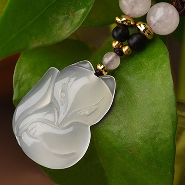 Collana con ciondolo in corda dell'armonia con perline di cristallo rosa di volpe e calcedonio Buddha Stones