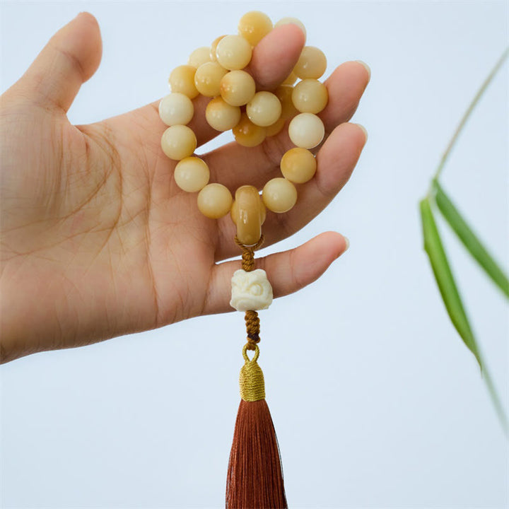 Buddha Stones Semi di Bodhi naturali Avorio Frutta Leone danzante Ciondolo Armonia Nappa Polso Mala