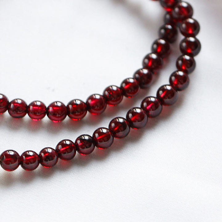 Bracciale Buddha Stones placcato oro 14K con quarzo fragola naturale e granato, stabilità a doppio giro