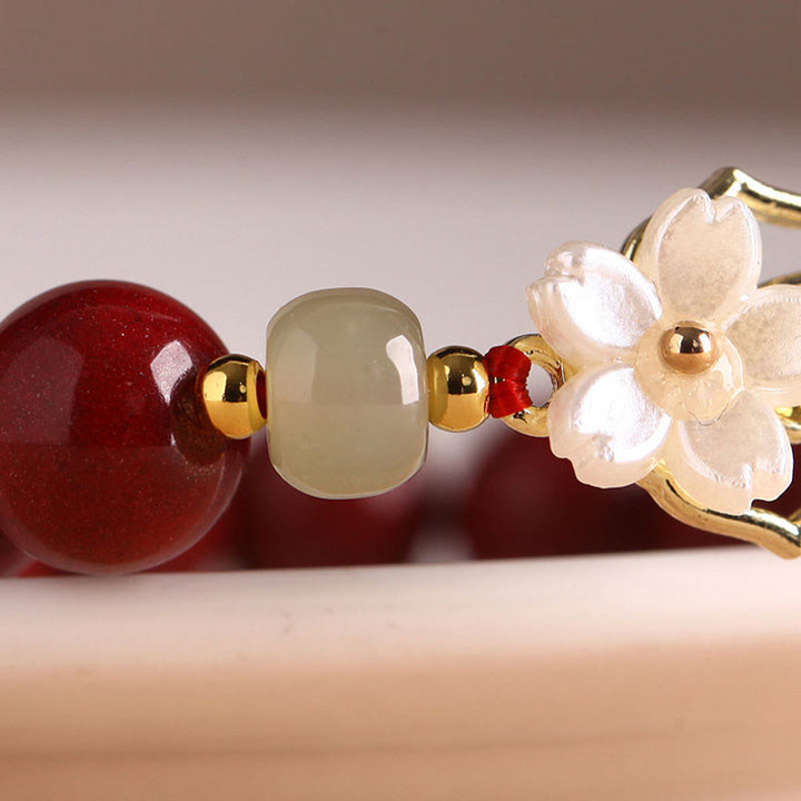 Braccialetto di benedizione con fiore di pietra di tridacna con perline di giada naturale di cinabro Buddha Stones