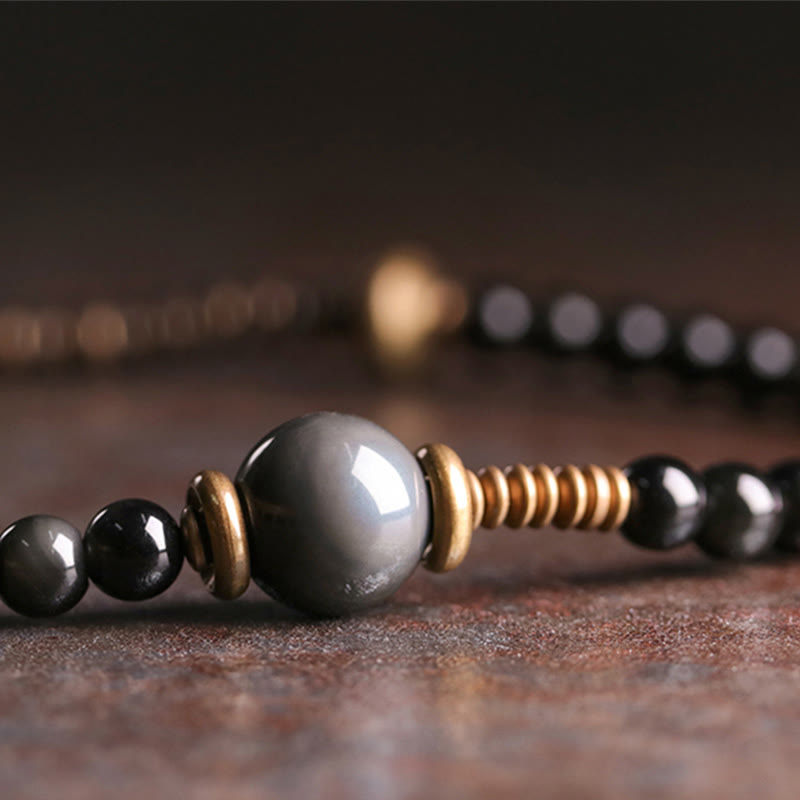 Braccialetto multistrato positivo in legno di ebano, ossidiana arcobaleno e rame Buddha Stones