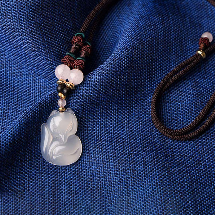 Collana con ciondolo in corda dell'armonia con perline di cristallo rosa di volpe e calcedonio Buddha Stones