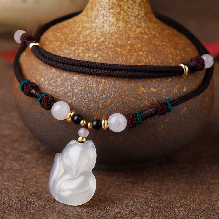 Collana con ciondolo in corda dell'armonia con perline di cristallo rosa di volpe e calcedonio Buddha Stones