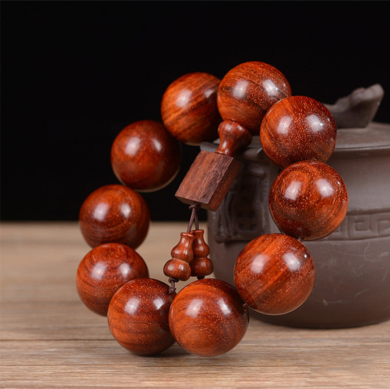 Braccialetto di rilassamento in legno di sandalo rosso con foglie piccole tibetane Buddha Stones