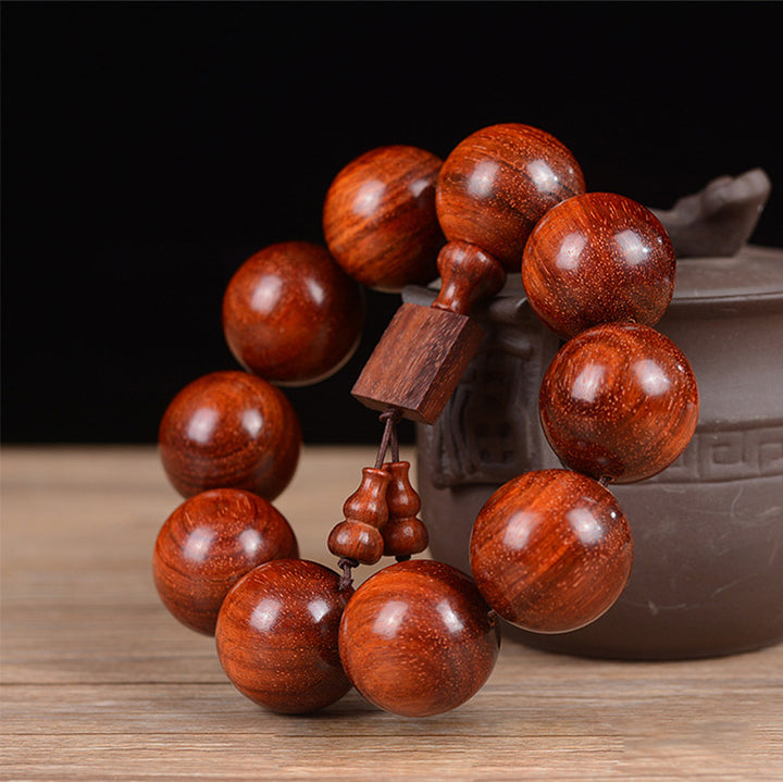 Braccialetto di rilassamento in legno di sandalo rosso con foglie piccole tibetane Buddha Stones