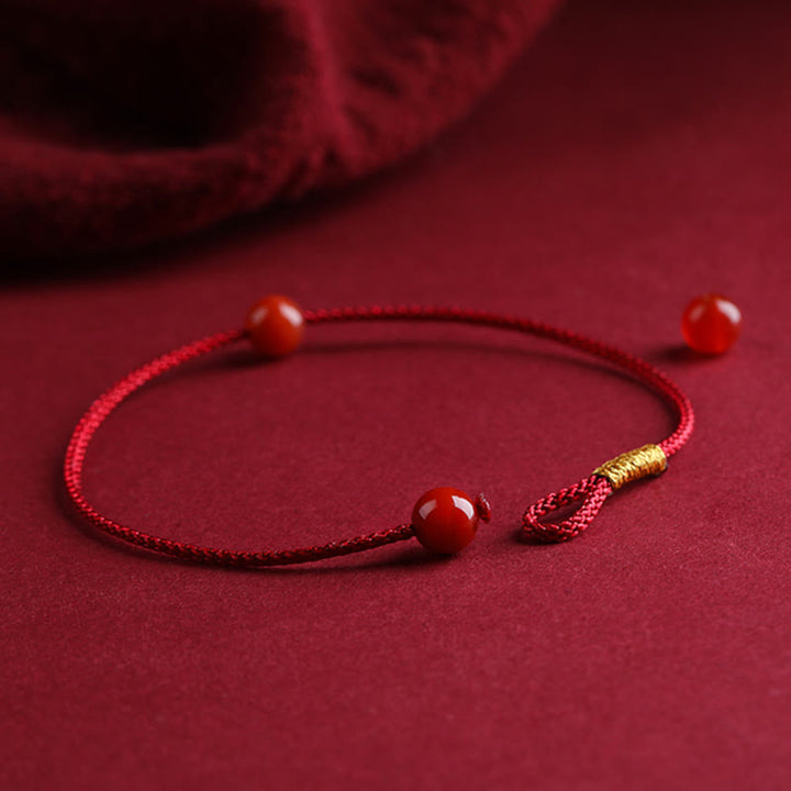 Braccialetto di corda rossa con benedizione in agata rossa naturale e cinabro Buddha Stones