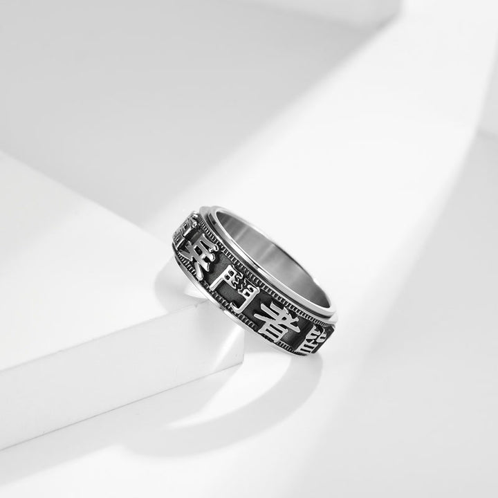 Anello girevole in acciaio al titanio con parole in equilibrio e calma
