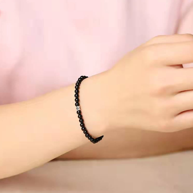 Bracciale Buddha Stones in ossidiana nera naturale e quarzo fumé per la forza di purificazione