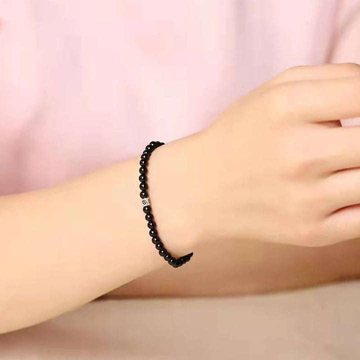 Bracciale Buddha Stones in ossidiana nera naturale e quarzo fumé per la forza di purificazione