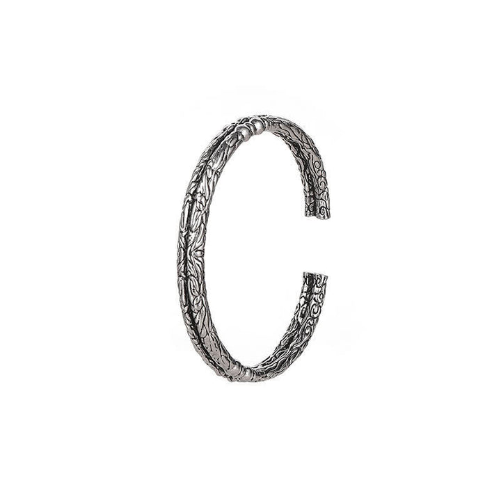 Bracciale rigido con polsino con motivo a drago inciso e bilanciamento