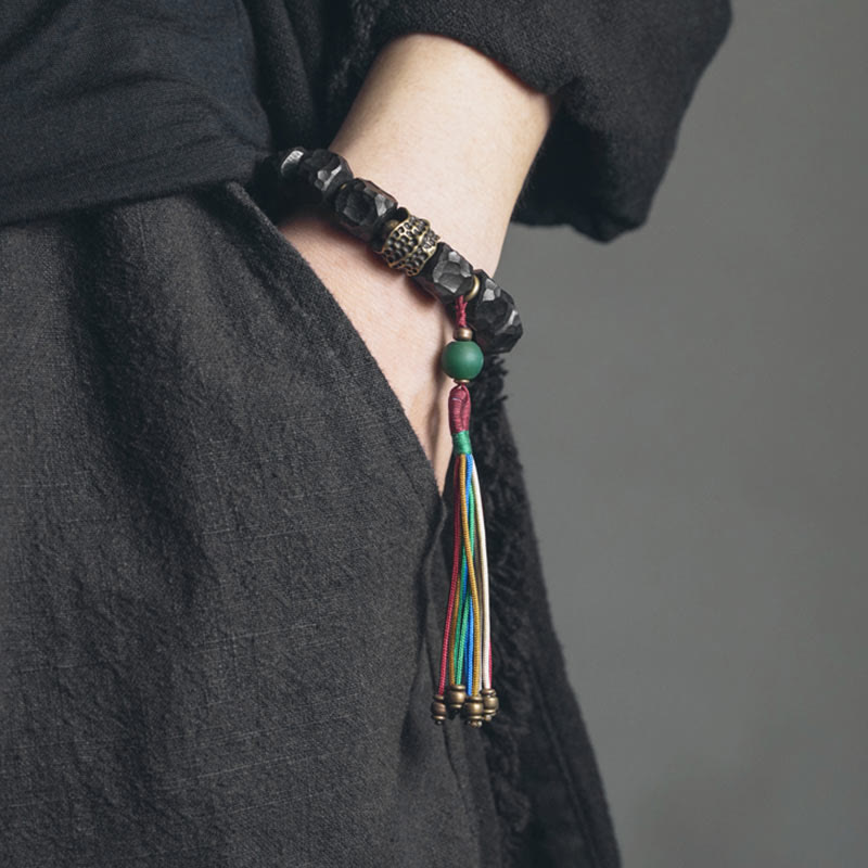 Bracciale Mala da polso con nappa in legno di Buddha Stones tibetano e rame della pace