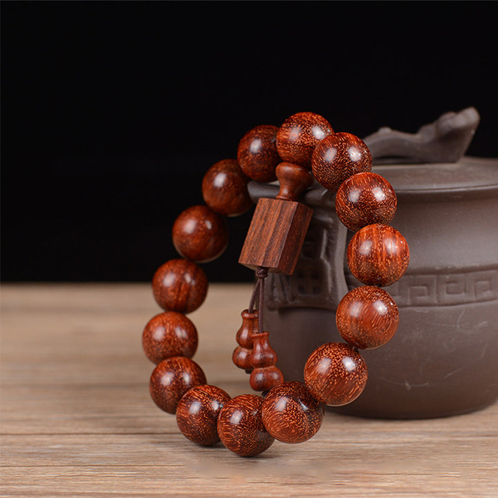 Braccialetto di rilassamento in legno di sandalo rosso con foglie piccole tibetane Buddha Stones
