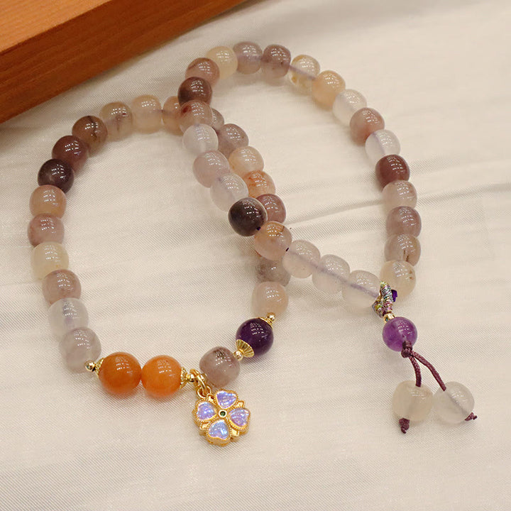 Braccialetto di perline con ciondolo a forma di fiore viola dorato naturale di seta Buddha Stones