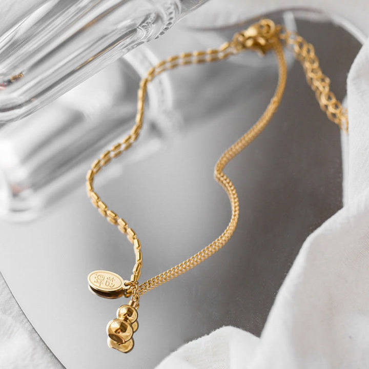 Cavigliera con fibbia della ricchezza e design a zucca portafortuna in oro 18k Buddha Stones