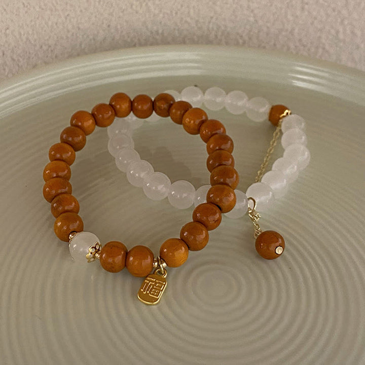 Braccialetto di protezione con ciondolo a forma di carattere Fu con occhio di gatto Buddha Stones in legno di sandalo