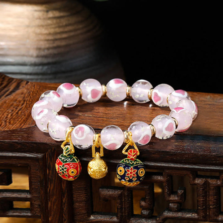 Braccialetto di perline di vetro fluorescente luminoso Liuli con cuore rosa della famiglia di bestie che ingoiano Buddha Stones