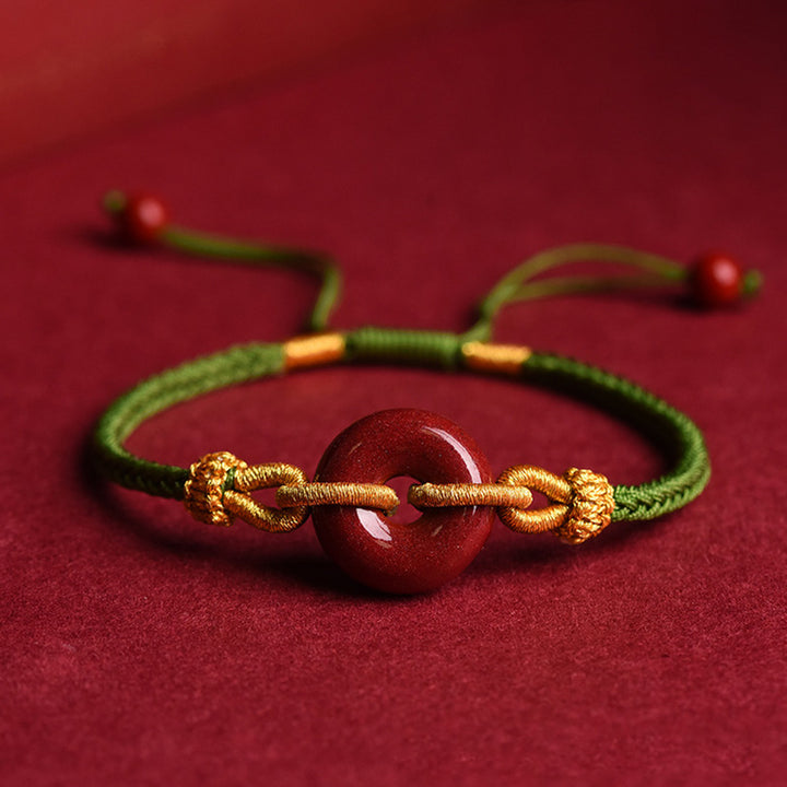 Bracciale intrecciato con motivo a fibbia per la pace in cinabro lavorato a mano Buddha Stones