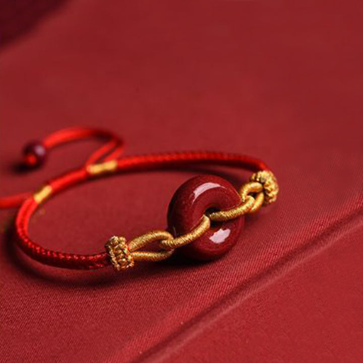 Bracciale intrecciato con motivo a fibbia per la pace in cinabro lavorato a mano Buddha Stones