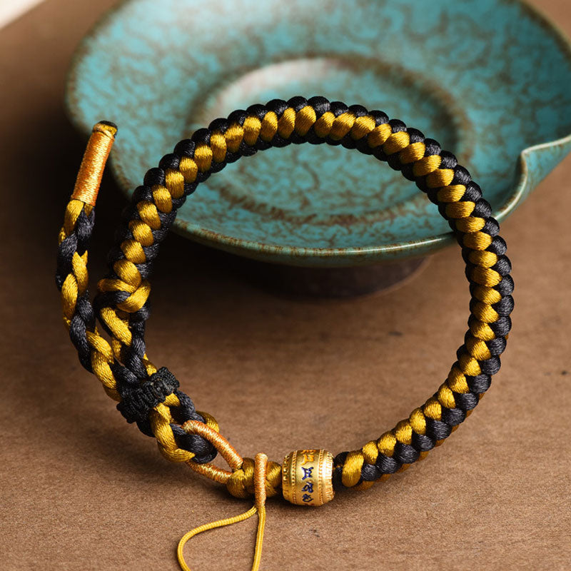 Braccialetto di purezza Om Mani Padme Hum in corda di scaglie di drago in oro nero tibetano fatto a mano con Buddha Stones