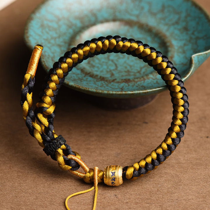 Braccialetto di purezza Om Mani Padme Hum in corda di scaglie di drago in oro nero tibetano fatto a mano con Buddha Stones