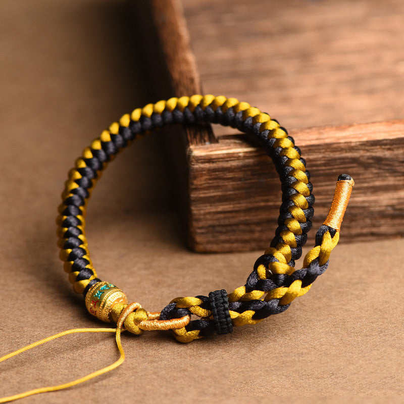 Braccialetto di purezza Om Mani Padme Hum in corda di scaglie di drago in oro nero tibetano fatto a mano con Buddha Stones