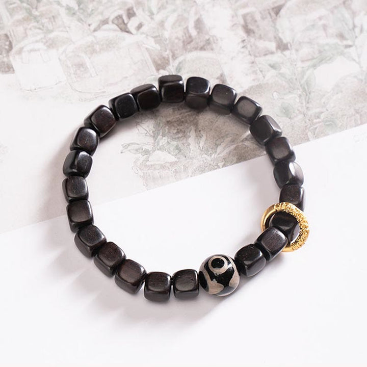 Braccialetto di equilibrio e calma con perline di legno di ebano tibetano Dzi Buddha Stones
