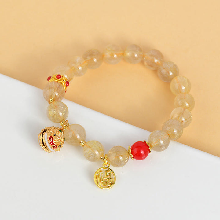 Braccialetto di ricchezza con ciondolo a forma di campana con carattere Fu in quarzo rutilato dorato naturale Buddha Stones