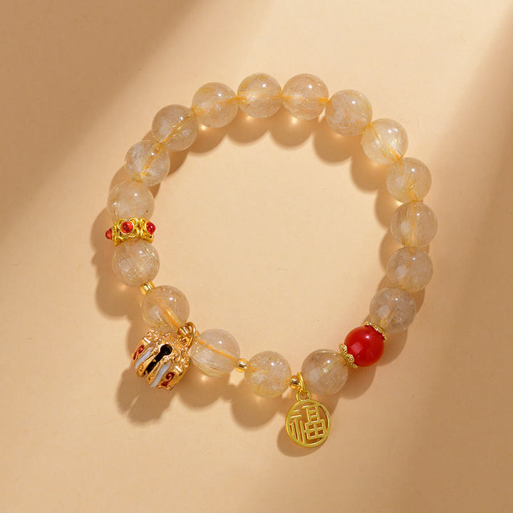 Braccialetto di ricchezza con ciondolo a forma di campana con carattere Fu in quarzo rutilato dorato naturale Buddha Stones