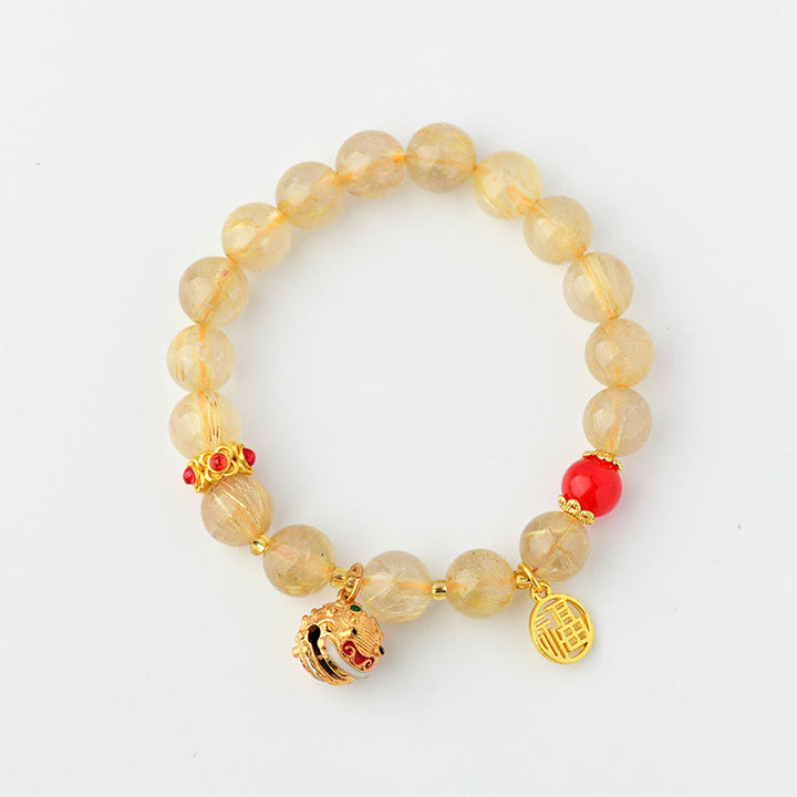 Braccialetto di ricchezza con ciondolo a forma di campana con carattere Fu in quarzo rutilato dorato naturale Buddha Stones