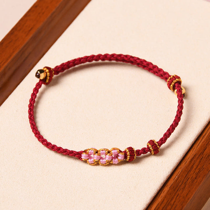 Braccialetto di corda intrecciata con protezione in fiore di pesco fatto a mano Buddha Stones